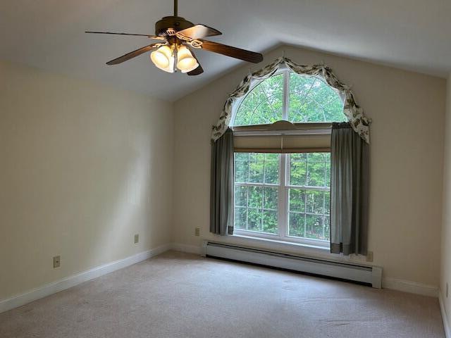 1 S Ridge Dr, Winslow, ME 04901 - empty room with a baseboard radiator, healthy amount of natural light, light colored carpet, a ceiling fan, and vaulted ceiling