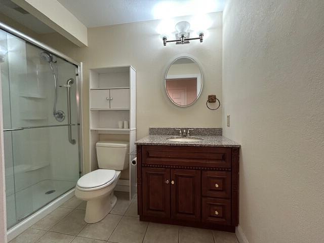 1 S Ridge Dr, Winslow, ME 04901 - full bathroom with vanity, a shower stall, and tile patterned flooring