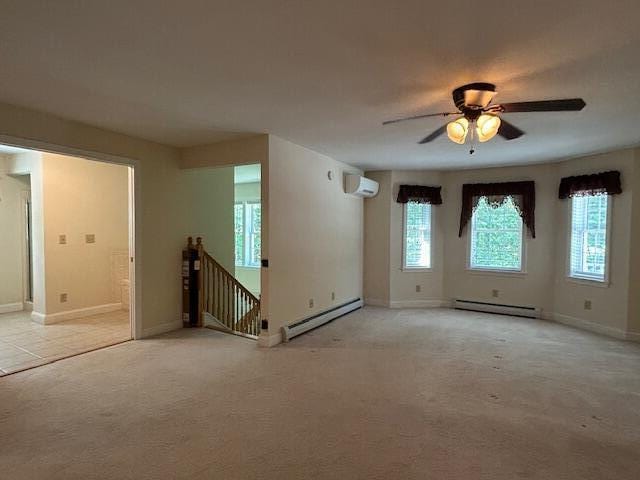 1 S Ridge Dr, Winslow, ME 04901 - empty room featuring baseboard heating, a baseboard radiator, a wall unit AC, ceiling fan, and light colored carpet