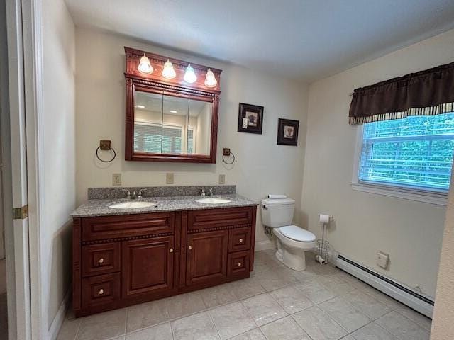 1 S Ridge Dr, Winslow, ME 04901 - bathroom with a baseboard radiator, double vanity, and tile patterned flooring