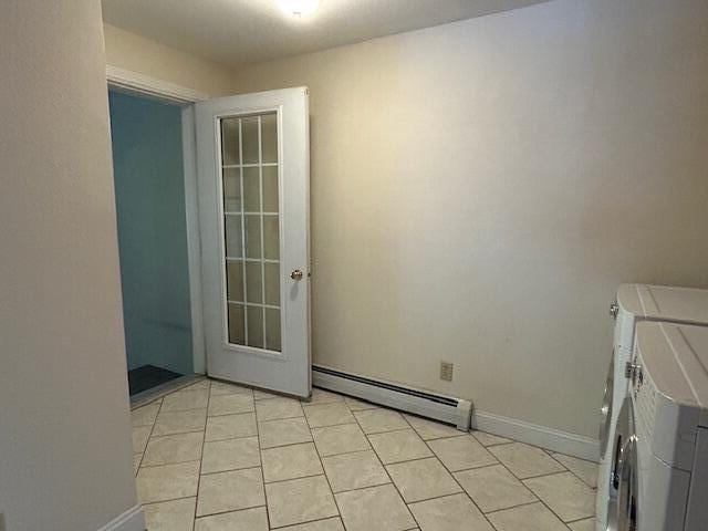 1 S Ridge Dr, Winslow, ME 04901 - spare room with baseboard heating, independent washer and dryer, and light tile patterned flooring
