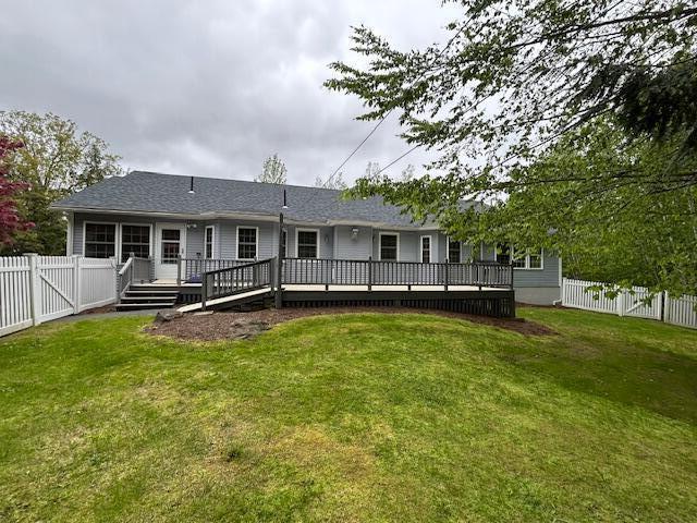 1 S Ridge Dr, Winslow, ME 04901 - back of property featuring a fenced backyard, a wooden deck, and a shingled roof