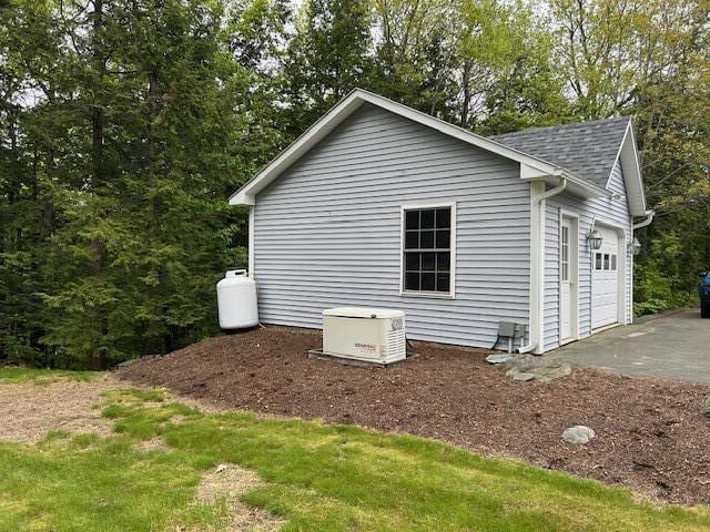 1 S Ridge Dr, Winslow, ME 04901 - view of home's exterior featuring roof with shingles and a detached garage