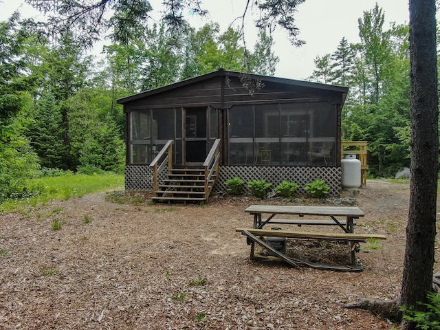 147 Loop Rd, Lincoln, ME 04457 - rear view of house featuring a sunroom