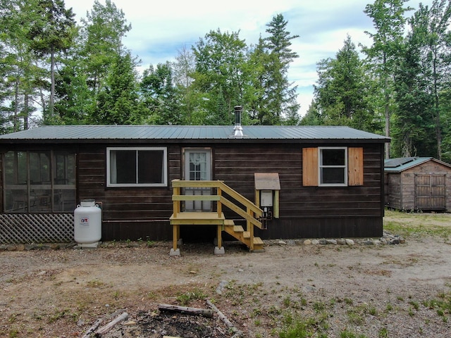 147 Loop Rd, Lincoln, ME 04457 - view of front of house with a shed and a metal roof