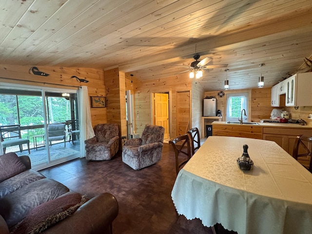 147 Loop Rd, Lincoln, ME 04457 - dining area with wood walls, dark wood-style floors, wood ceiling, and ceiling fan