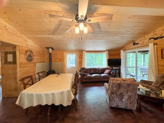 147 Loop Rd, Lincoln, ME 04457 - dining area with vaulted ceiling, wooden walls, wood ceiling, plenty of natural light, and a wood stove