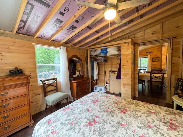 147 Loop Rd, Lincoln, ME 04457 - bedroom featuring wood walls, lofted ceiling, multiple windows, a closet, and dark wood finished floors