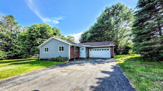 30 Grand Ave, Millinocket, ME 04462 - single story home featuring driveway, a garage, brick siding, and a front yard