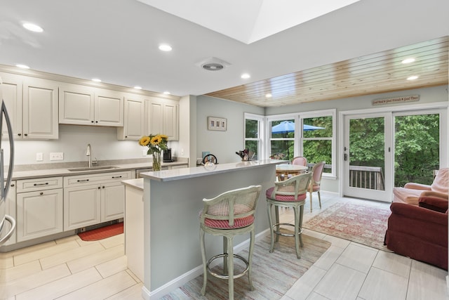 44 Ellen Cir, Yarmouth, ME 04096 - kitchen featuring a kitchen breakfast bar, a center island, recessed lighting, light countertops, and open floor plan