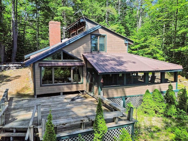 8 Horseshoe Is, Winthrop, ME 04364 - rear view of house with a wooden deck, a chimney, a forest view, and a metal roof