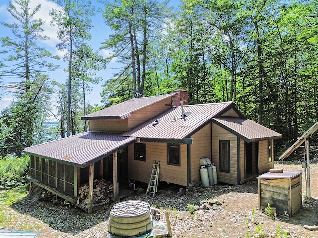 8 Horseshoe Is, Winthrop, ME 04364 - rear view of house with a sunroom, a chimney, and a metal roof