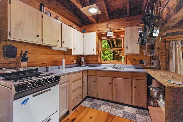 8 Horseshoe Is, Winthrop, ME 04364 - kitchen featuring white gas range oven, light countertops, light wood-style flooring, beamed ceiling, and wooden walls