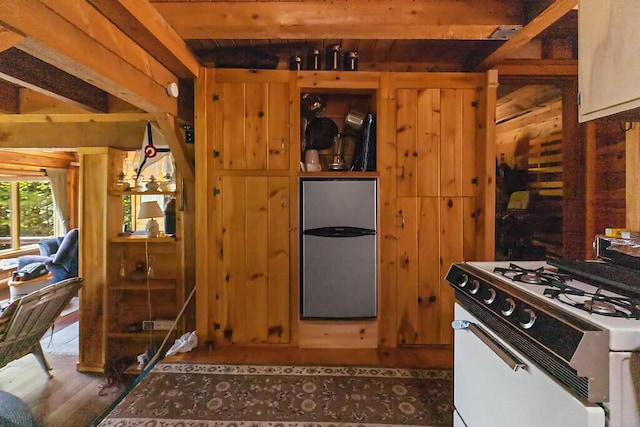 8 Horseshoe Is, Winthrop, ME 04364 - kitchen featuring white gas range oven, wood finished floors, freestanding refrigerator, and a wood ceiling with exposed beams