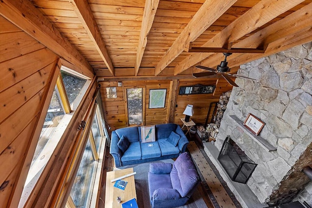 8 Horseshoe Is, Winthrop, ME 04364 - living area featuring wooden walls, a wood ceiling with exposed beams, a stone fireplace, and a ceiling fan