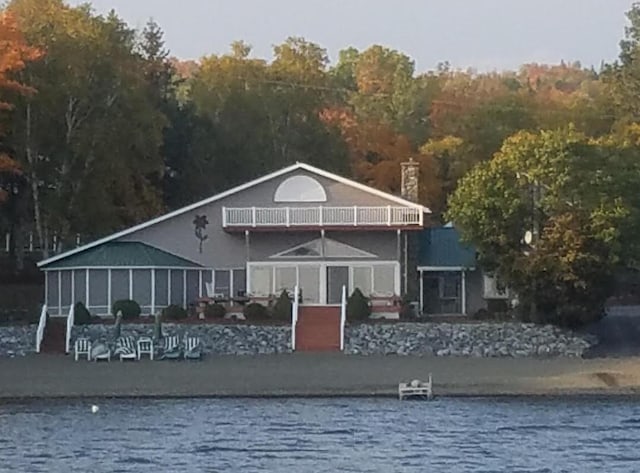 13 S Brook Ln, Eagle Lake, ME 04739 - back of property with a balcony, a water view, and a forest view