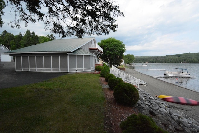 13 S Brook Ln, Eagle Lake, ME 04739 - view of yard with a sunroom, a water view, and a dock