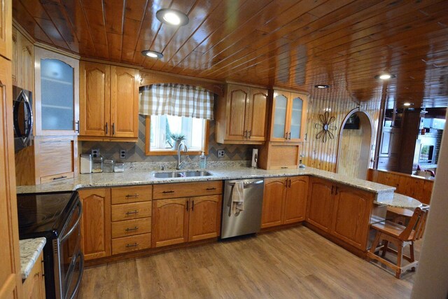 13 S Brook Ln, Eagle Lake, ME 04739 - kitchen with stainless steel appliances, wood ceiling, glass insert cabinets, a peninsula, and light stone countertops