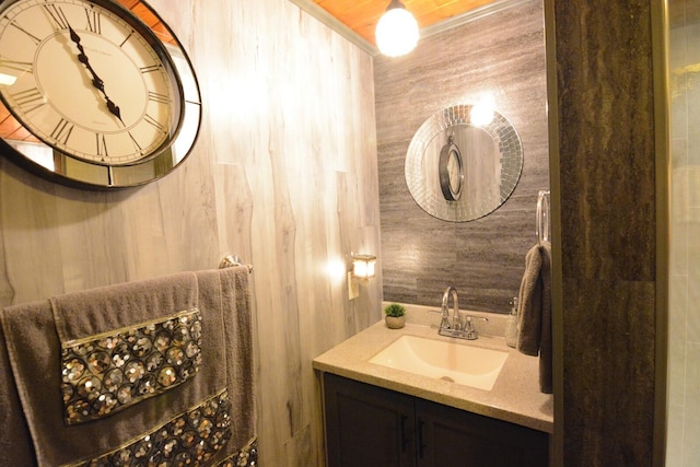 13 S Brook Ln, Eagle Lake, ME 04739 - bathroom featuring wooden walls and vanity