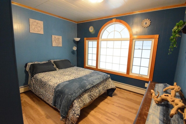 13 S Brook Ln, Eagle Lake, ME 04739 - bedroom featuring baseboard heating, ornamental molding, and wood finished floors