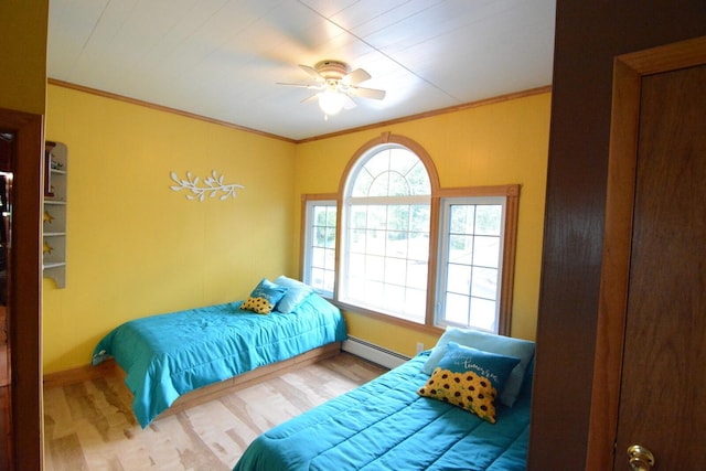 13 S Brook Ln, Eagle Lake, ME 04739 - bedroom featuring a baseboard radiator, wood finished floors, ornamental molding, and a ceiling fan