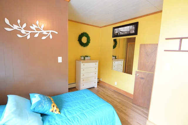 13 S Brook Ln, Eagle Lake, ME 04739 - bedroom featuring wood finished floors, baseboard heating, and crown molding