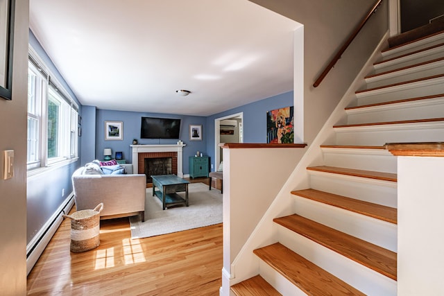 325 Ludlow St, Portland, ME 04102 - staircase featuring a baseboard radiator, wood finished floors, and a fireplace