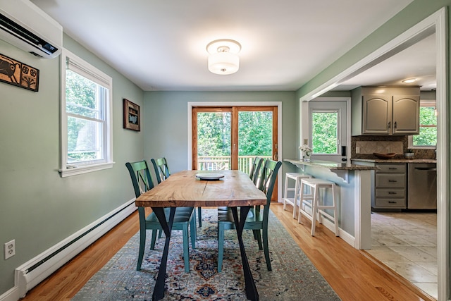 325 Ludlow St, Portland, ME 04102 - dining room featuring a baseboard heating unit, a wall mounted air conditioner, and light wood-type flooring