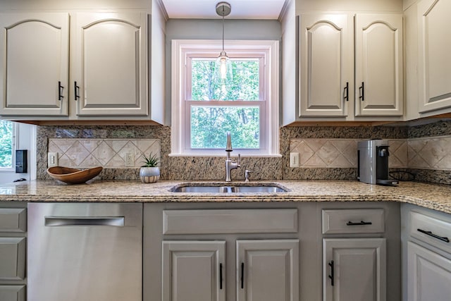 325 Ludlow St, Portland, ME 04102 - kitchen with dishwasher, backsplash, hanging light fixtures, and light stone countertops