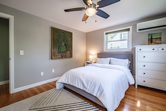 325 Ludlow St, Portland, ME 04102 - bedroom with a wall unit AC, wood finished floors, and a ceiling fan