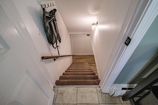 325 Ludlow St, Portland, ME 04102 - staircase with marble look tile flooring and baseboards