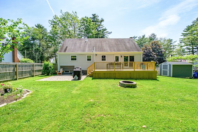325 Ludlow St, Portland, ME 04102 - back of house with an outdoor fire pit, a wooden deck, a storage shed, a fenced backyard, and a patio area