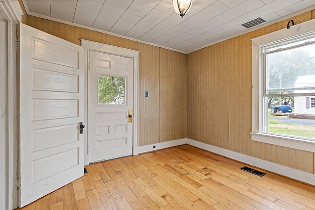 7 James St, Bingham, ME 04920 - entryway featuring light wood-style flooring, crown molding, and wooden walls
