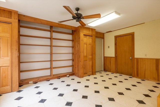 391 Main Rd, Islesboro, ME 04848 - spare room with wainscoting, ceiling fan, light floors, and wood walls