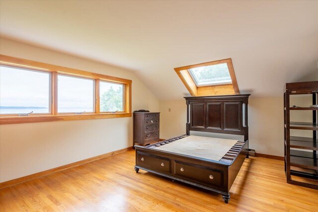 391 Main Rd, Islesboro, ME 04848 - bedroom with a skylight, vaulted ceiling, and light wood-style floors