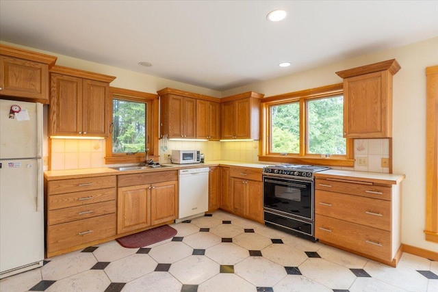 391 Main Rd, Islesboro, ME 04848 - kitchen featuring white appliances, light countertops, decorative backsplash, and recessed lighting