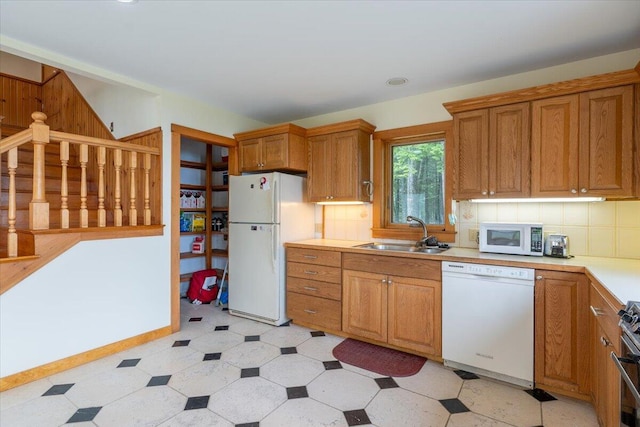 391 Main Rd, Islesboro, ME 04848 - kitchen featuring white appliances, light countertops, light floors, and brown cabinets