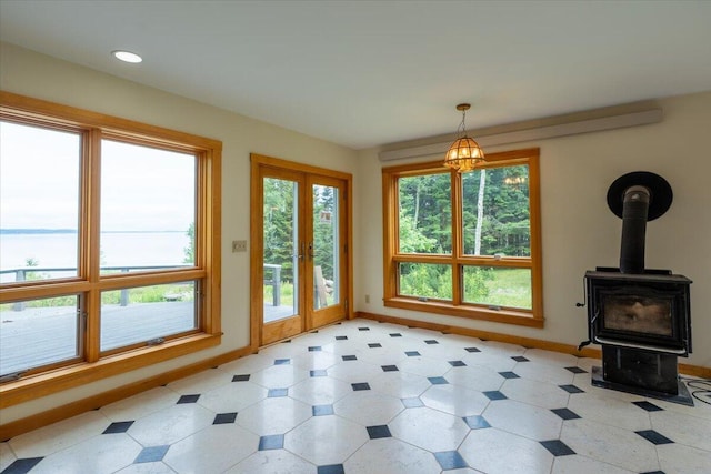 391 Main Rd, Islesboro, ME 04848 - unfurnished living room with light floors, french doors, and a wood stove