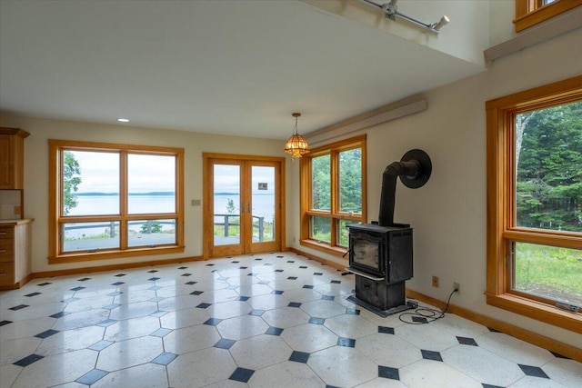391 Main Rd, Islesboro, ME 04848 - unfurnished living room with healthy amount of natural light, light flooring, recessed lighting, and a wood stove