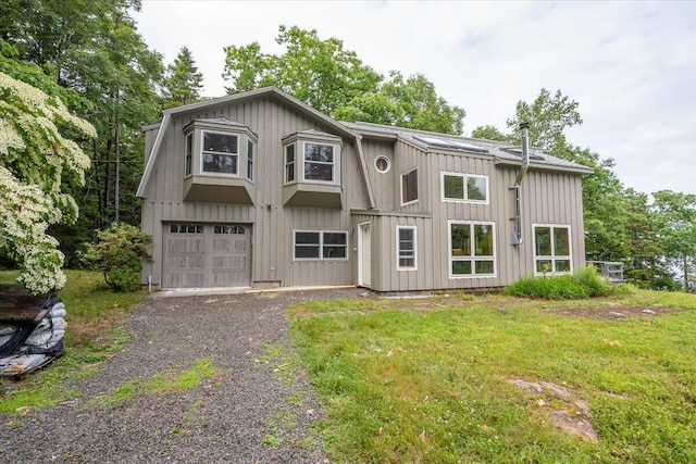 391 Main Rd, Islesboro, ME 04848 - view of front of house featuring board and batten siding, gravel driveway, and an attached garage