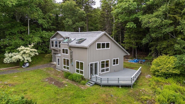 391 Main Rd, Islesboro, ME 04848 - back of house featuring a shingled roof, a deck, a lawn, and a forest view