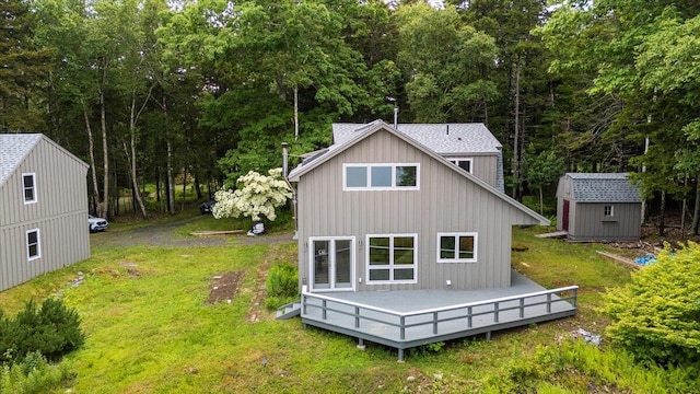 391 Main Rd, Islesboro, ME 04848 - back of house with a shed, a wooden deck, a yard, and board and batten siding