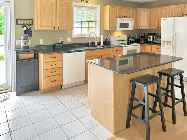 1016 State St Unit 7, Bangor, ME 04401 - kitchen featuring white appliances, light brown cabinets, a kitchen island, and a breakfast bar