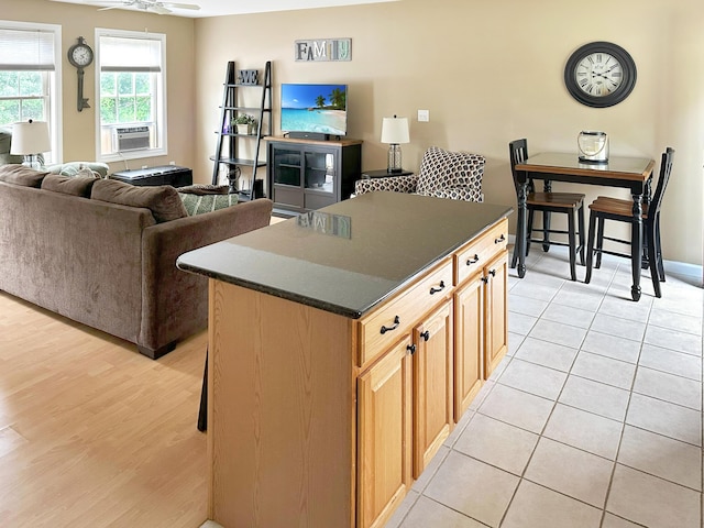 1016 State St Unit 7, Bangor, ME 04401 - kitchen with dark countertops, a ceiling fan, cooling unit, a center island, and light wood finished floors