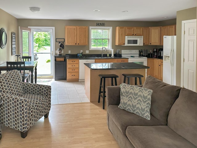 1016 State St Unit 7, Bangor, ME 04401 - kitchen featuring white appliances, open floor plan, dark countertops, a center island, and light wood-style floors