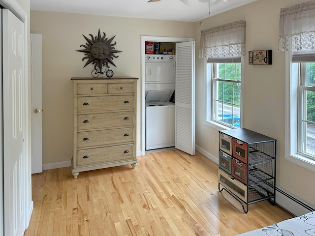 1016 State St Unit 7, Bangor, ME 04401 - bedroom with stacked washing machine and dryer, light wood finished floors, and multiple windows