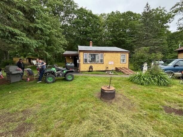 258 Guinea Rd, Biddeford, ME 04005 - view of front of home featuring a front yard and a chimney