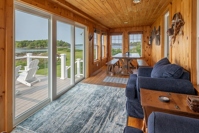 122 Isle Of Springs Rd, Boothbay, ME 04537 - sunroom / solarium featuring wood-type flooring, wooden ceiling, wood walls, and a deck with water view