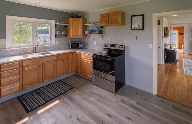 122 Isle Of Springs Rd, Boothbay, ME 04537 - kitchen with appliances with stainless steel finishes, open shelves, light countertops, light wood-style floors, and tasteful backsplash