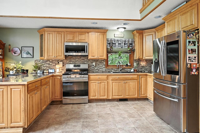 146 Lone Indian Trl, Augusta, ME 04330 - kitchen featuring appliances with stainless steel finishes, a peninsula, backsplash, a textured ceiling, and recessed lighting